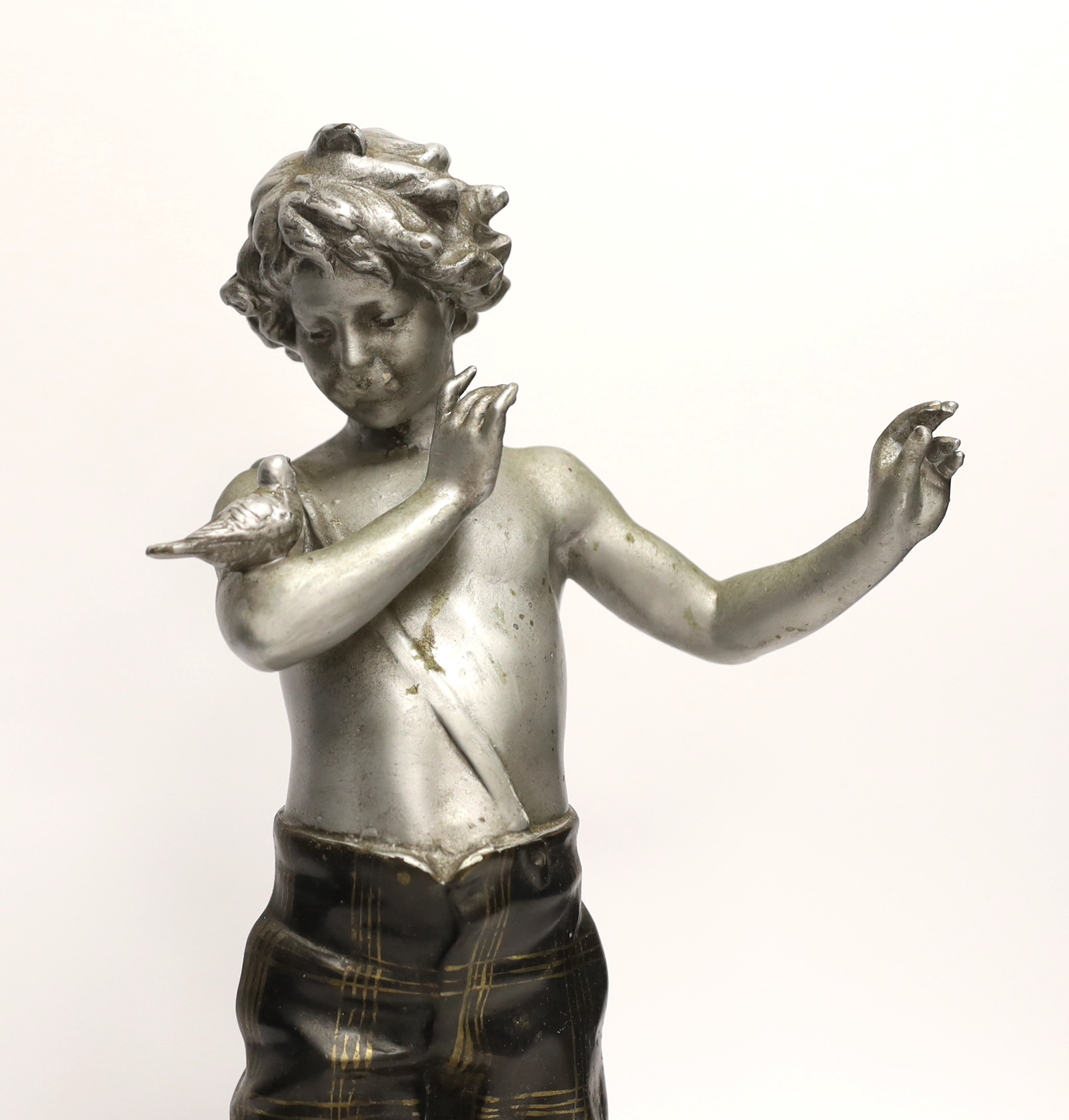 A spelter figure of a boy with bird on two step marble base, 39.5cm high